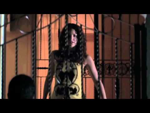 Trailer still: Luisito (La Soga) framed against the Malecón, with low strings and hand percussion implied