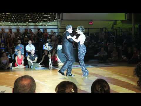  Fabian Salas  and  Lola Diaz  are  dancing  to  the  tango  "  Tus palabras y la noche  "  by  Carlos di Sarli  at  A los amigos tango festival  in  2019