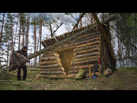 Building a warm and cozy bushcraft shelter with a stove on a reservoir