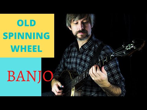 guy in black shirt playing a banjo
