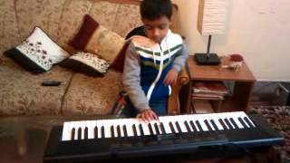 Kid playing keyboard