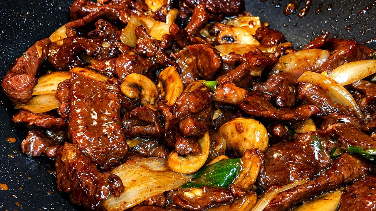 Better Than Takeout Beef and Onion Mushroom Stir Fry in a pan by BeSureToCook