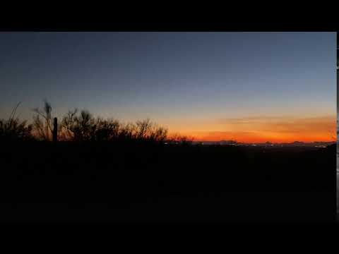 View of the cacti and sunset over Tucson. This is shot from the front of our site, where the car is parked.