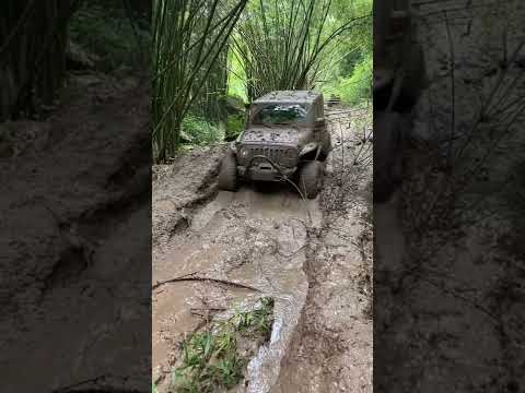 Off road in big rain mud trail with Jeep Wrangler JL
