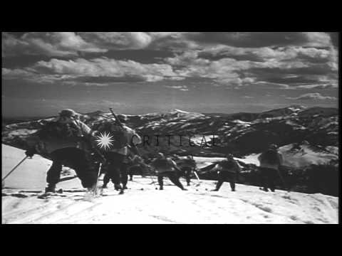 Fully equipped troops advancing and sliding downhill along the snow covered area ...HD Stock Footage