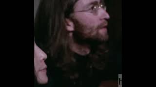 John Lennon looks at footage of himself performing at the Cavern Club in 1962.