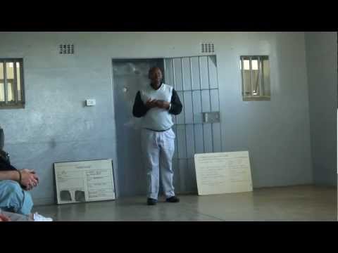Robben Island ex prisoner explaining hard prison conditions in cell. Nelson Mandela