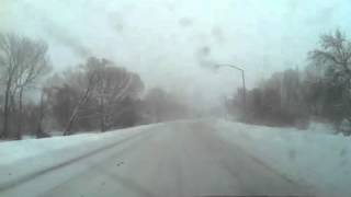 Semi truck passing fast on snowy freeway