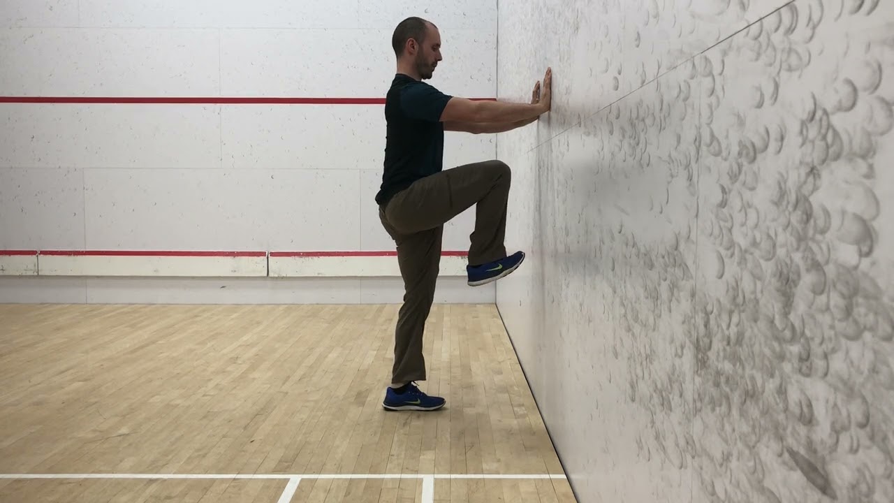 7. Wall Supported Standing Hip Flexion (Side View)