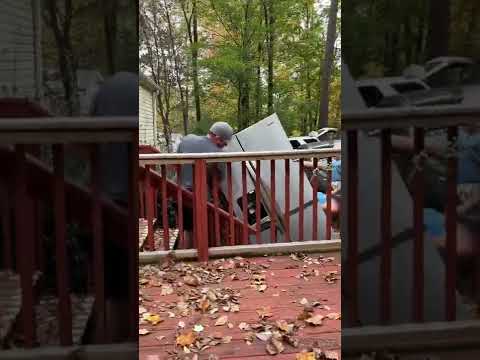 My dad is picking up a Fridge  out of a house￼