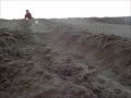 tape rolling down a sand dune