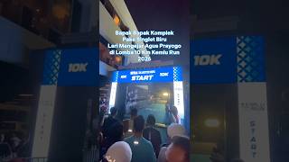 Download lagu Middle-aged man in a blue tank top chases Agus Prayogo at the 2026 Kemlu Run 10K mp3