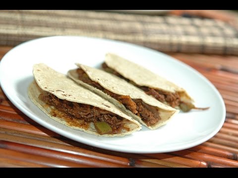 Shredded beef tacos in pasilla chili pepper sauce...