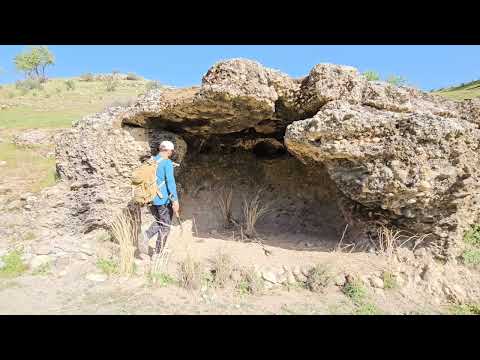 rebuilding a cave.Building a survival Stone Shelter in rainstorm. designing a mudy wall and firplace