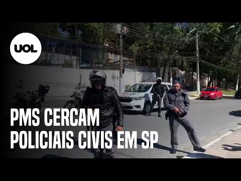 Military police officers surround civil police officers and say "they're killing us"