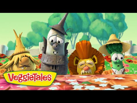 Three VeggieTales characters lean over a flowered table with the VeggieTales logo in the foreground.