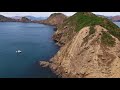 Fly through the narrow gap from Wakaterepapanui Island to Puangiangi Island. See if you can spot the boat along the way!