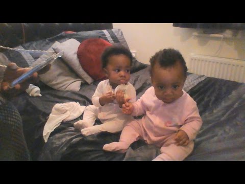 8 month twin girls love the camera