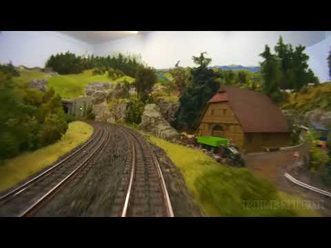 Cab ride on a model railroad layout with hidden railway station in HO scale