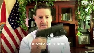 "I can do whatever I want with my gun."  Congressman displays weapons during debate.