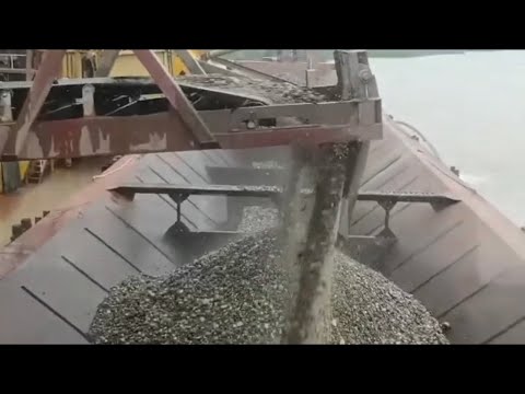 Barge unloading 4000 tons of cobblestone , my daily work on the river