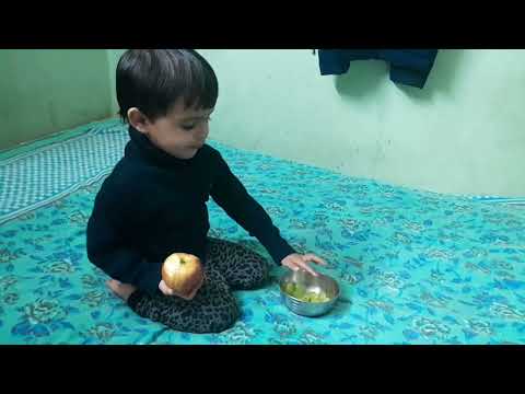 Insiya washing fruits before eating.