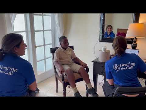 Nine year old hears for the first time when he is fit with hearing aids.