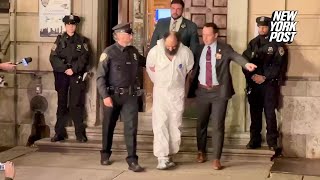 Suspected NYC killer, Ramon Rivera walking out of NYC’s 10th Precinct with police