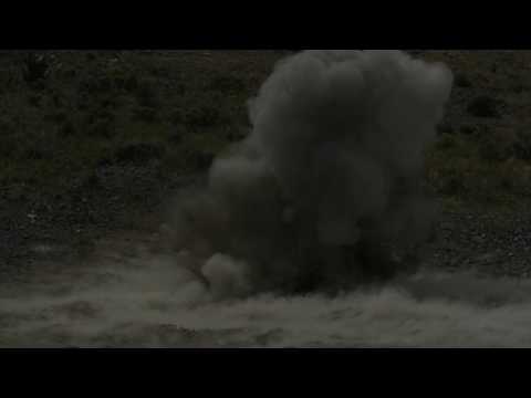 Fiery explosion in slow motion, shock wave visible.