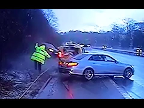 Near-miss for police officer as car skids out of control on motorway