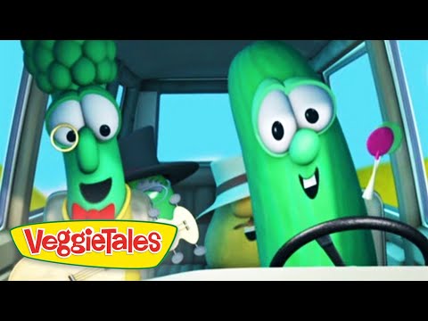Two green VeggieTales characters riding in a car, smiling at the camera, with the VeggieTales logo in the lower-left corner.