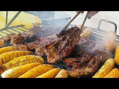 Street Food in Lima, Peru. Grilling Amazon Fish, Bananas and Cutting Pork