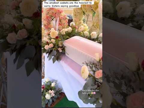 Baby funeral with sisters saying goodbye by loving on the baby one final time by touching the casket