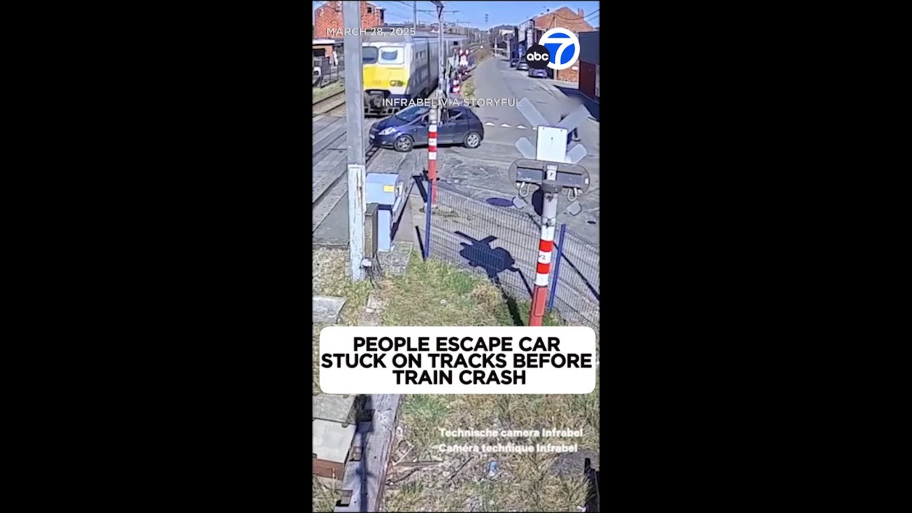 2 escape car stuck on tracks seconds before train smashes it