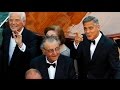 GEORGE CLOONEY leads a star studded parade of.