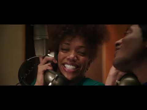 Official trailer still: Naomi Ackie as Whitney Houston bathed in spotlights on a concert stage