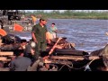 Vietnamese aboard sampans approach a barge complex on the Cua Lon River during Op...HD Stock Footage