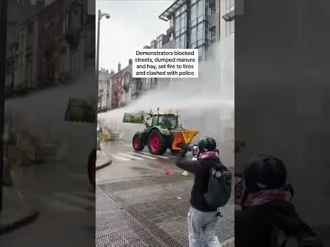 Farmers smash through police barricades and dump manure in protest over EU policies