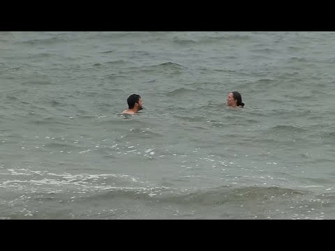 Swimmers take dip in ocean off Cape Cod before rain, wind intensify with nor'easter