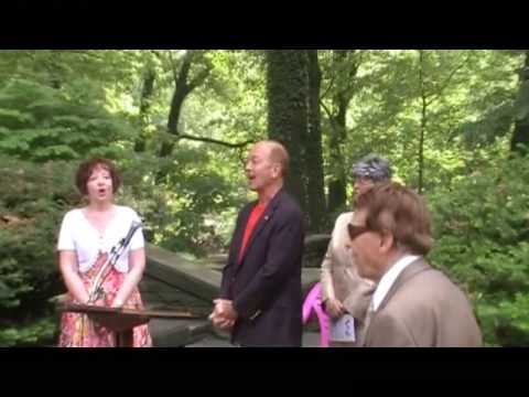 Concluding Polish song Sto lat at the Madame Marie Sklodowska Curie statue rededication event