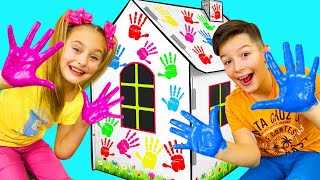 Sasha paints Cardboard Playhouses with colored Hands