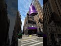 A man rings a giant bell in the middle of city