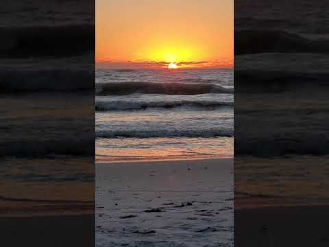 Sunset over ocean, ocean waves, Anna Maria Island, white sand, sunset in Florida.