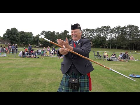 Drum Major Bill Barclay demonstrates the skill of the Mace Flourish during Ballater Games in 2021
