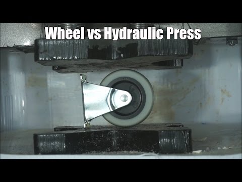 Industrial Wheel Crushed By Hydraulic Press