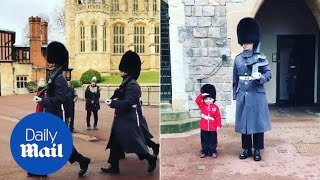 Four-year-old boy salutes next to guardsman at Win
