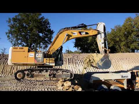 Caterpillar 374F loading Volvo A40G