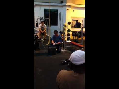 Brooks Kubik lifting two 36 kg dumbbells in London