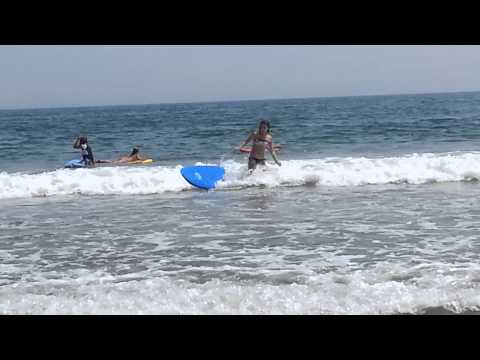 Kenna surfing the waves at the beach