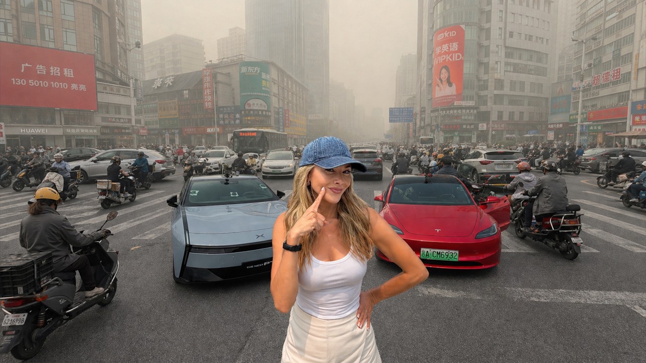 Xpeng P7 center screen showing its self-driving system tracking pedestrians and scooters on a dense Chinese city street during Kim Java's test